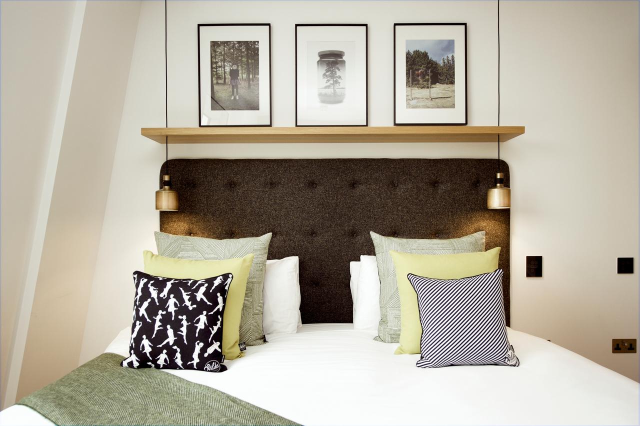 Double bed with cushions and above light fixtures